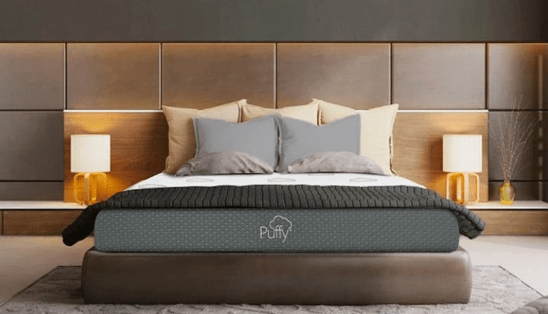 A Puffy Original mattress against a wooden bedroom.