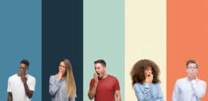 Group of people over vintage colors background bored yawning tired covering mouth with hand. Restless and sleepiness. Sleep deprivation statistics concept.