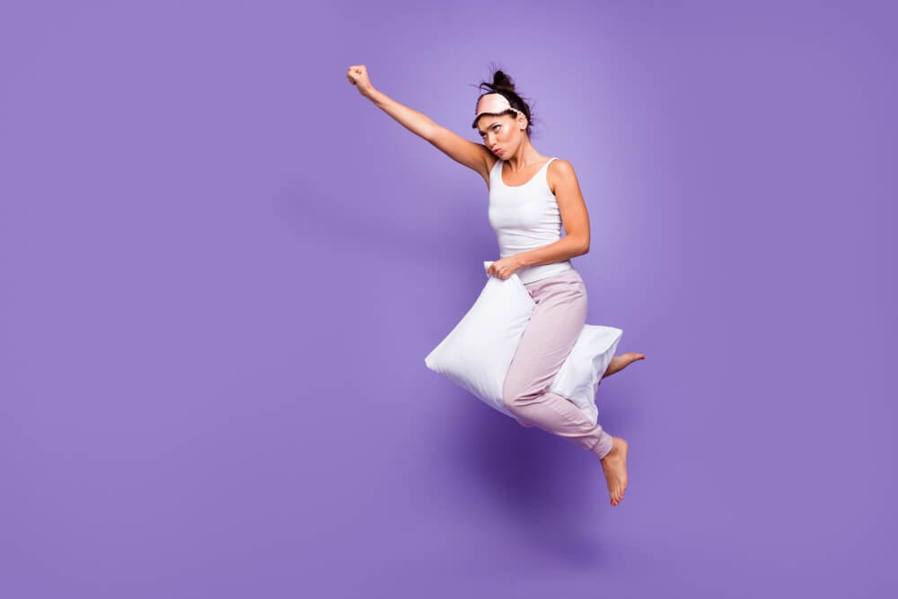 Full length side profile body size photo beautiful she her lady super power flight hold between legs down pillow funny satisfied wear sleeping mask pants tank-top pajamas isolated violet purple background.