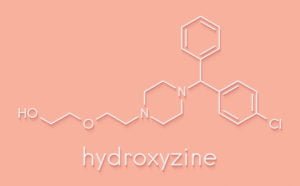 A white chemical outline of Hydroxyzine, or Vistaril, on a pink background.