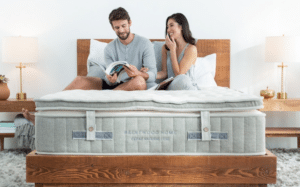A man and woman relax on a Brentwood Home Cedar Natural Luxe mattress.
