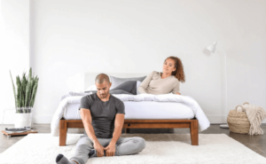 Two people relax with their Thuma bed frame.