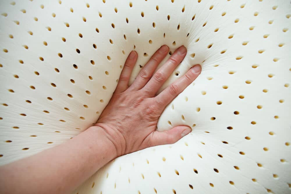 perforated latex mattress and pillow texture with hand on it