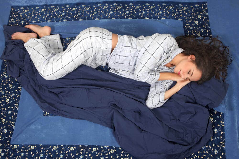 Woman sleeping in side position, in comfort on bed