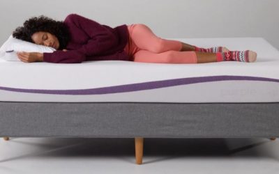 A woman sleeping on the purple mattress.
